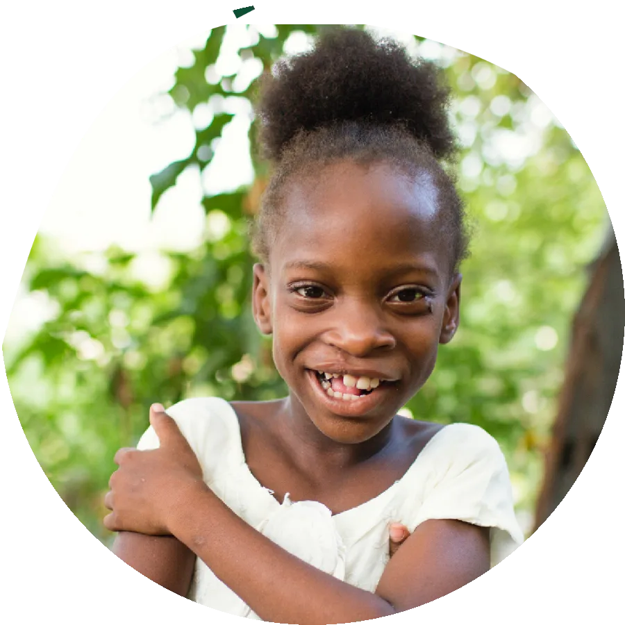 Portrait of a smiling seven year old girl, standing in for the persona Penelope